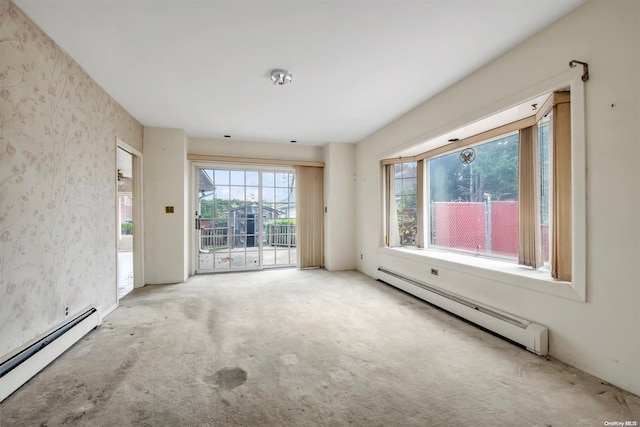 carpeted empty room with a baseboard radiator