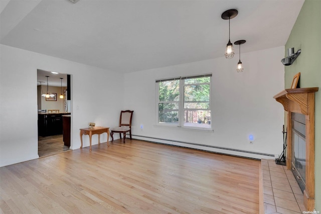 living room with light hardwood / wood-style flooring and a baseboard radiator