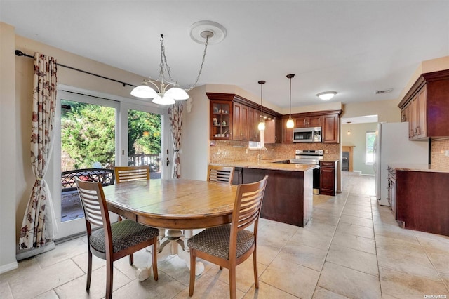 dining area with sink and an inviting chandelier