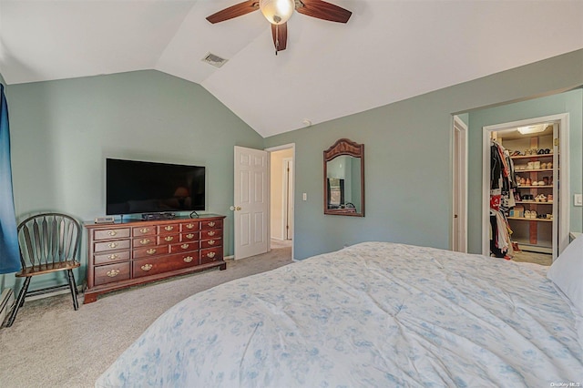 carpeted bedroom featuring a walk in closet, baseboard heating, ceiling fan, a closet, and lofted ceiling