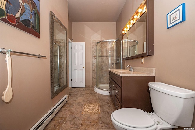 bathroom featuring toilet, a shower with door, vanity, and a baseboard heating unit