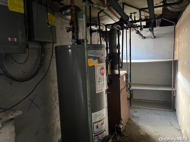 utility room featuring water heater