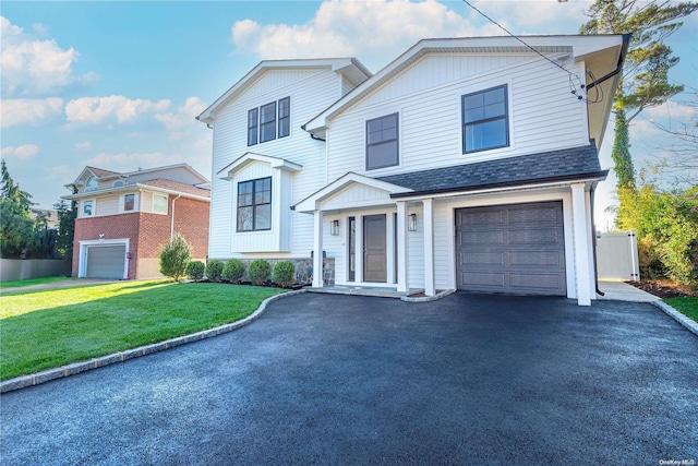 view of property with a front yard and a garage