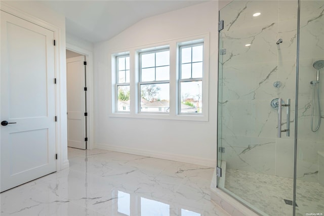 bathroom with a shower with door and vaulted ceiling