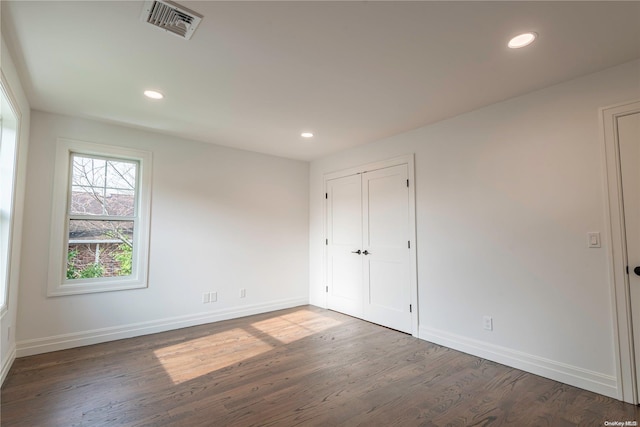 unfurnished bedroom with dark wood-type flooring