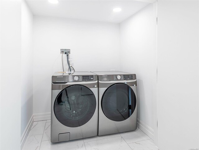 1956 Leonard Ln, Merrick, NY 11566 - laundry area with washer and dryer, marble look tiles, baseboards, and recessed lighting