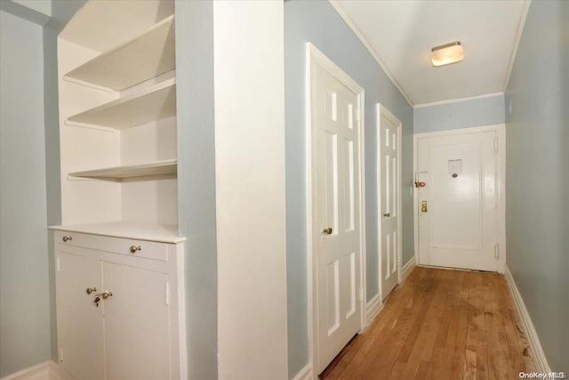 corridor featuring ornamental molding and light wood-type flooring