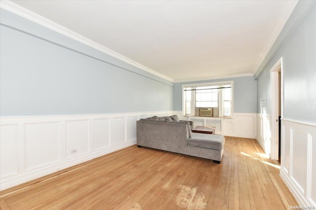 living room featuring crown molding and light hardwood / wood-style floors