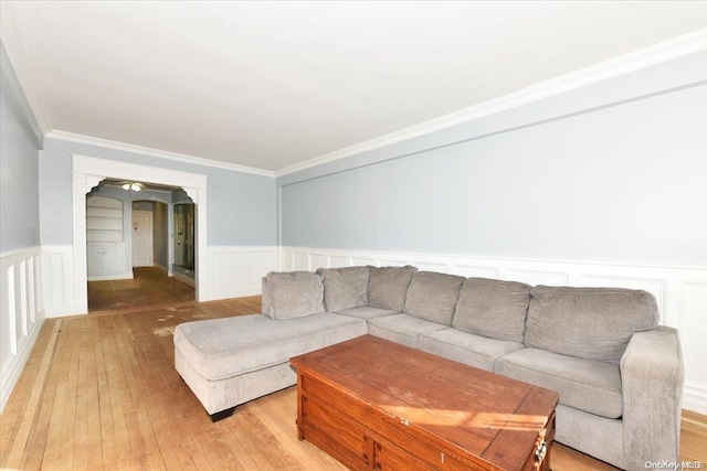 living room with light hardwood / wood-style floors and ornamental molding