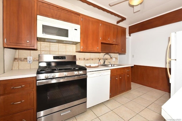 kitchen featuring white appliances, sink, decorative backsplash, ceiling fan, and light tile patterned flooring