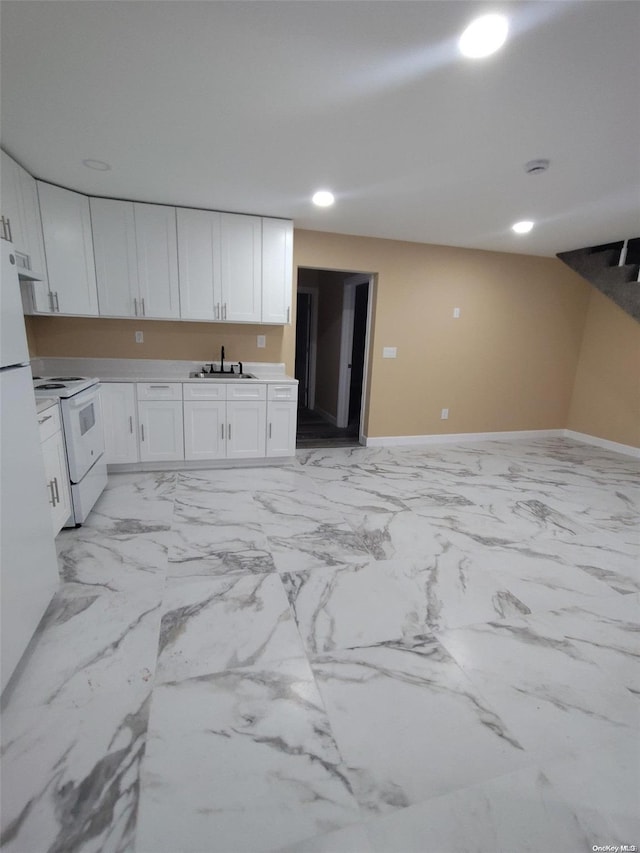 kitchen with white cabinets, sink, and white electric stove