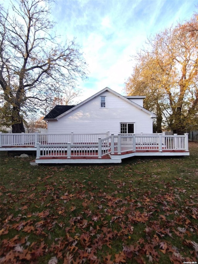 back of house with a lawn and a wooden deck