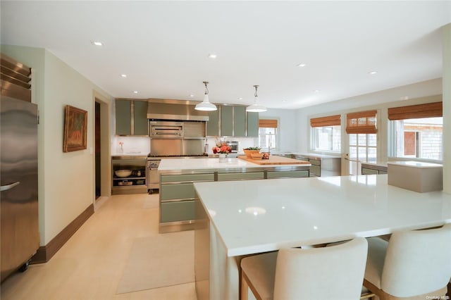 4170/3375 Indian Neck Ln, Peconic, NY 11958 - kitchen with gray cabinetry, a breakfast bar, hanging light fixtures, built in refrigerator, and a kitchen island