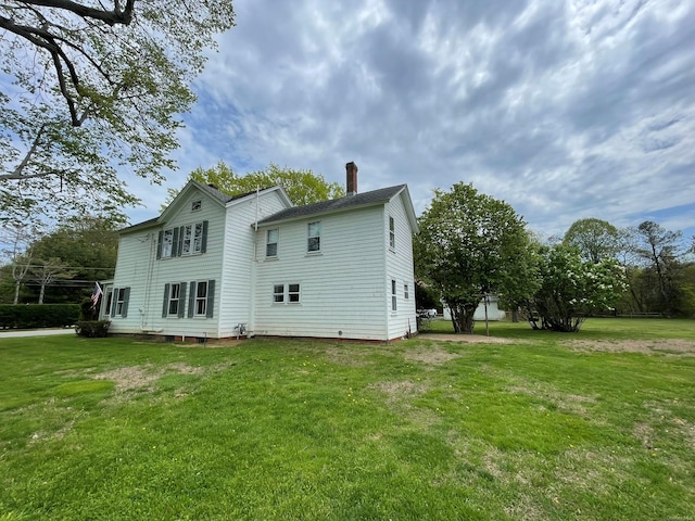 2055 Boisseau Ave, Southold, NY 11971 - rear view of property featuring a chimney and a lawn