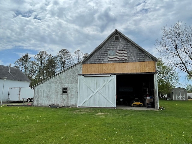 2055 Boisseau Ave, Southold, NY 11971 - view of barn featuring a lawn and a storage shed