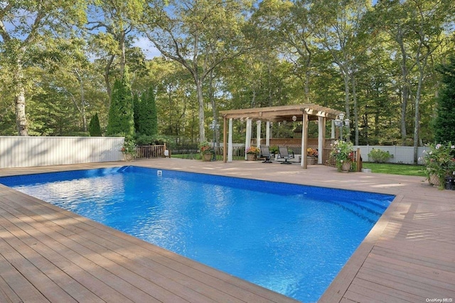 view of swimming pool with a deck and a pergola