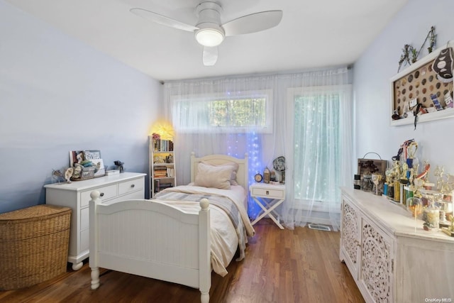 bedroom with ceiling fan and dark wood-type flooring