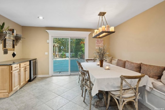 tiled dining space featuring wine cooler