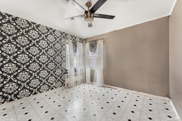 spare room with ceiling fan and ornamental molding