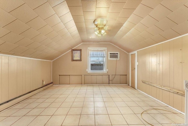 bonus room featuring wood walls, lofted ceiling, a wall unit AC, and a baseboard heating unit