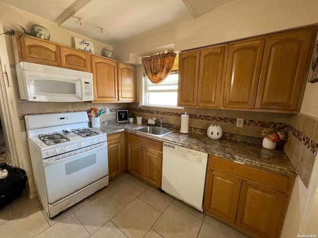 kitchen with white appliances, sink, and light tile patterned floors