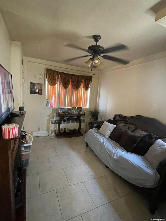 tiled living room featuring ceiling fan and a healthy amount of sunlight