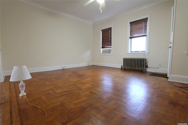 spare room featuring ceiling fan, radiator heating unit, dark parquet floors, and ornamental molding