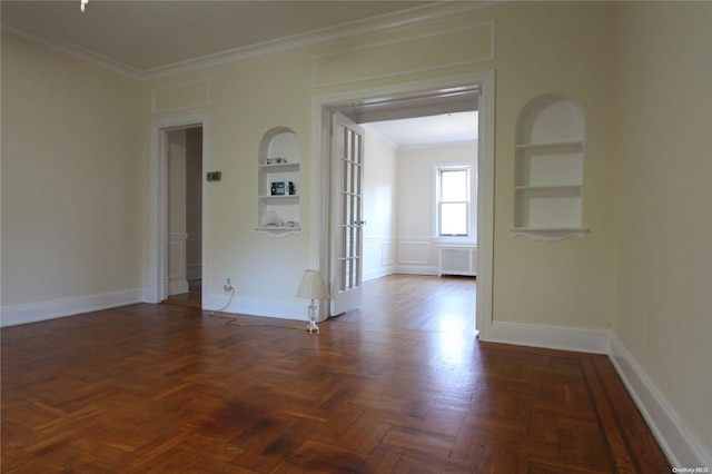 unfurnished room with dark parquet flooring, french doors, radiator, ornamental molding, and built in shelves