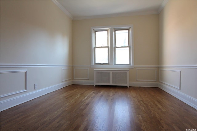 unfurnished room featuring radiator heating unit, dark wood-type flooring, and ornamental molding