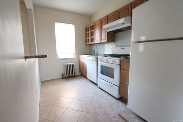 kitchen with white appliances, tasteful backsplash, radiator, and light tile patterned flooring