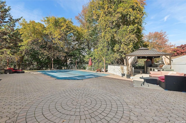 view of pool featuring a gazebo, an outdoor living space, a grill, and a patio