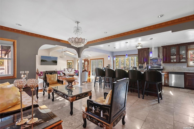 living room featuring a notable chandelier and light tile patterned flooring