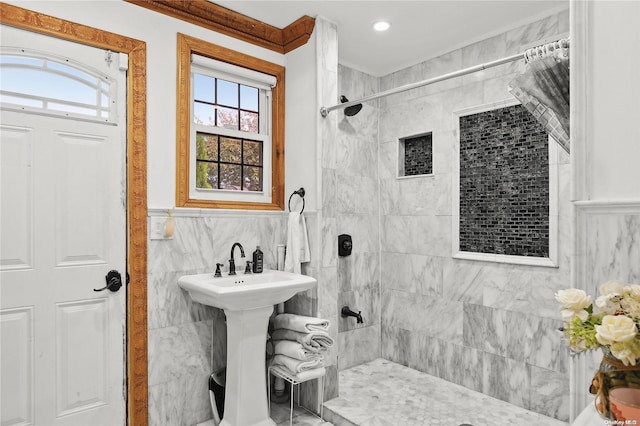 bathroom featuring a tile shower and tile walls