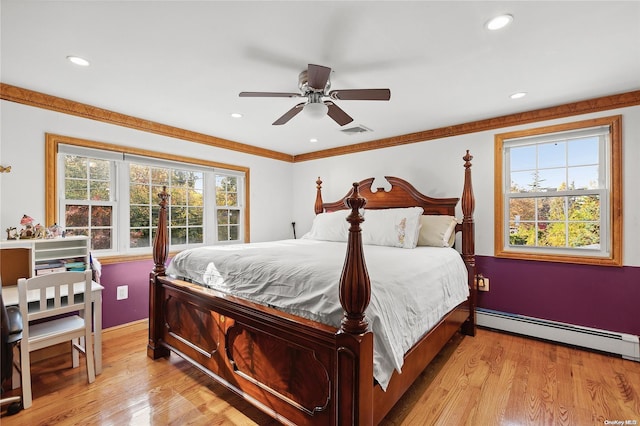 bedroom featuring a baseboard radiator, light hardwood / wood-style flooring, multiple windows, and ceiling fan