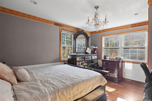 bedroom featuring hardwood / wood-style flooring and a notable chandelier