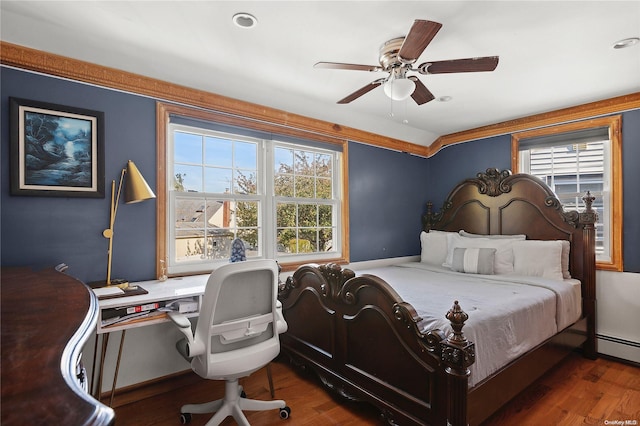 bedroom featuring multiple windows, dark wood-type flooring, and ceiling fan