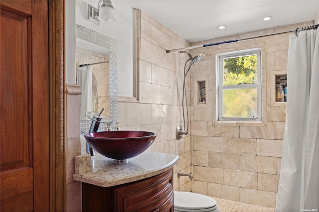 bathroom with vanity, toilet, tile walls, and curtained shower