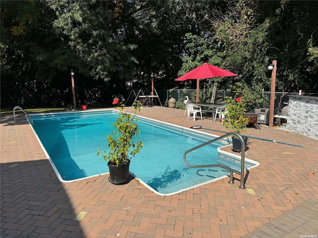 view of swimming pool featuring a patio