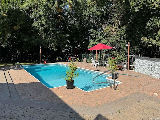 view of swimming pool with a patio area