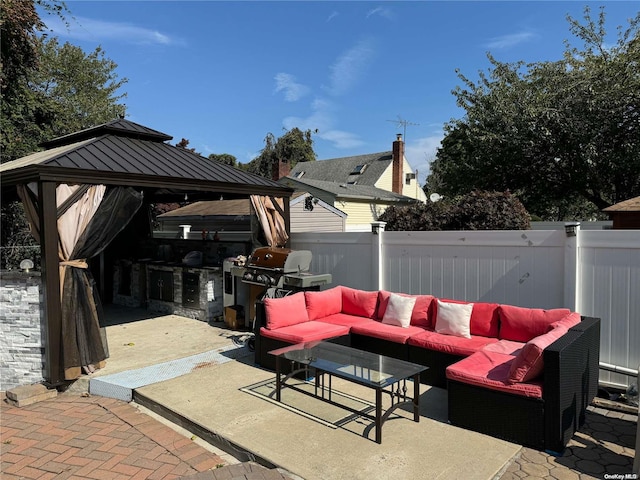 view of patio / terrace featuring a gazebo, grilling area, an outdoor living space, and an outdoor kitchen