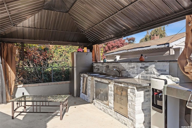 view of patio / terrace featuring a gazebo, sink, and exterior kitchen