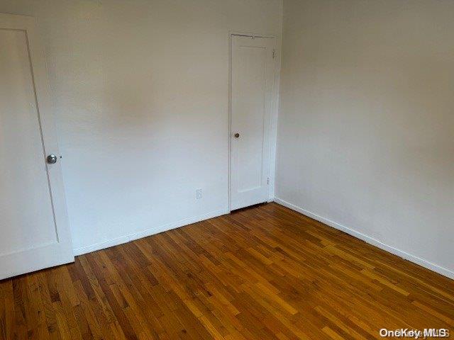 spare room with dark hardwood / wood-style flooring