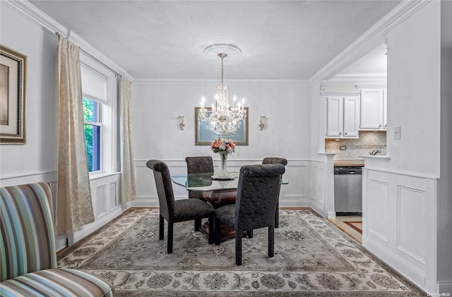 dining space with crown molding and an inviting chandelier