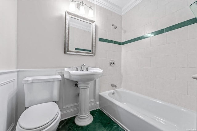 bathroom featuring tile patterned floors, toilet, tiled shower / bath, and crown molding