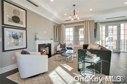 living room featuring a notable chandelier and a raised ceiling