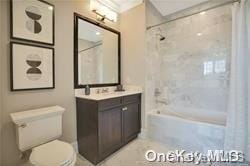 full bathroom with vanity, shower / bathtub combination with curtain, and toilet