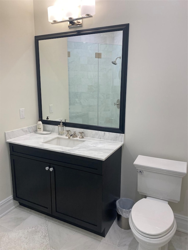 bathroom featuring tile patterned flooring, vanity, a shower with shower door, and toilet