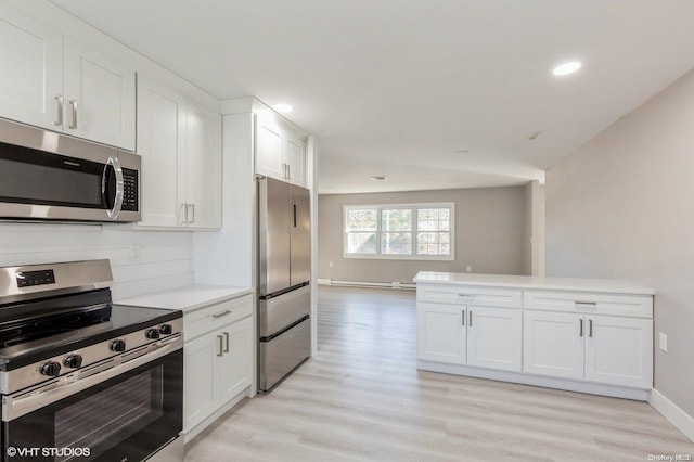 kitchen with light hardwood / wood-style flooring, white cabinets, stainless steel appliances, and a baseboard radiator