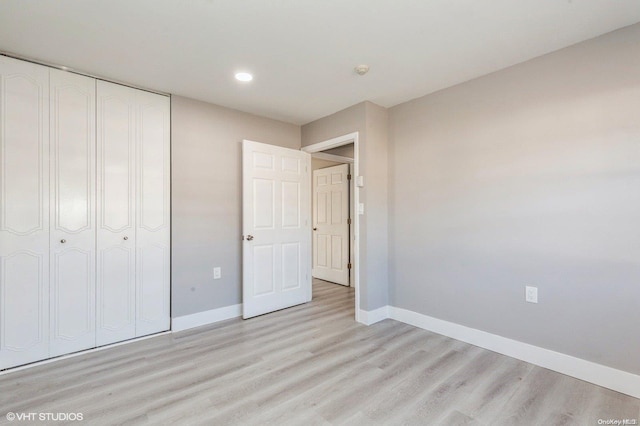 unfurnished bedroom featuring a closet and light hardwood / wood-style floors