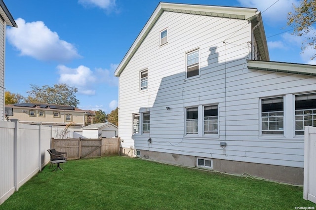 rear view of house with a lawn